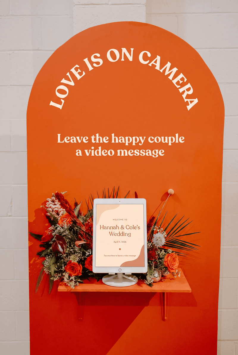 A wedding guest recording a video message on the iPad guestbook
